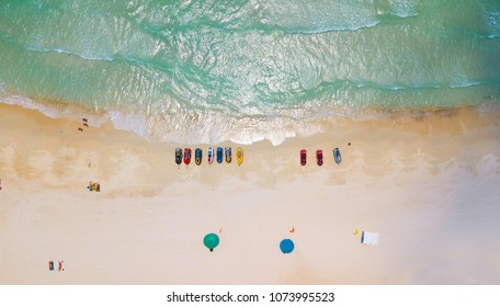 Aerial : Overhead  Of People Enjoying The Summer At Sand  Beach ,waves Breaking Against The Coast Line