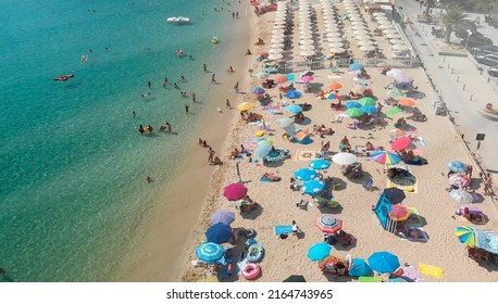 Aerial Overhead View Of Lined Beach Umbrellas On A Tropical Beach.