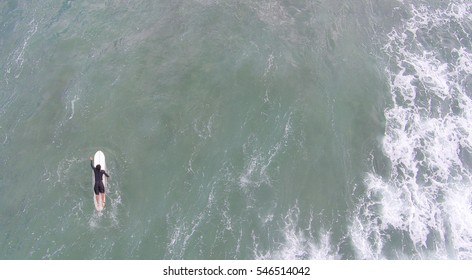 Aerial overhead view of surfer on the ocean