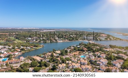Aerial overview of luxury villas located around Quinta do Lago, Algarve, Portugal, Europe. Drone shot in the green zone.