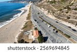 Aerial Pacific Palisades, CA, Santa Monica Bay, Will Rogers State Beach. Cars on Pacifica Coast Highway, Highway 1, surfers, parking lot, lifeguard station 2025 Jan 5