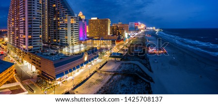 Aerial panorama of Atlantic city along the boardwalk at dusk. In the 1980s, Atlantic City achieved nationwide attention as a gambling resort and currently has nine large casinos.