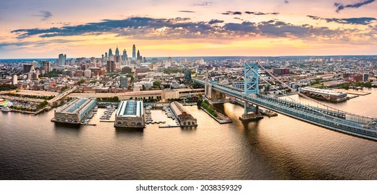 Aerial panorama with Ben Franklin Bridge and Philadelphia skyline at sunset. Ben Franklin Bridge is a suspension bridge connecting Philadelphia and Camden, NJ.