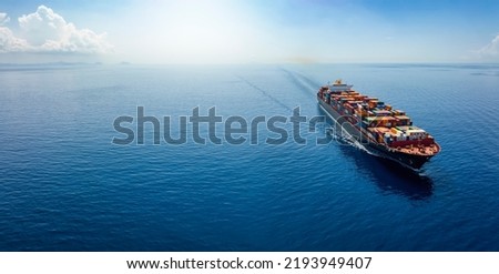 Aerial panorama of a cargo ship carrying container for import and export, business logistic and transportation in open sea with copy space  商業照片 © 