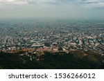 Aerial panorama of the city of Cali taken from the top of Cristo del Rey against a blue sky. Colombia