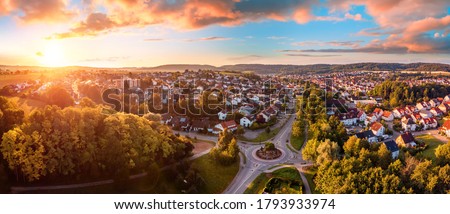 Aerial panorama of a European town at sunrise, with magnificent colorful sky and warm light