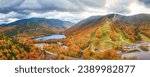 Aerial panorama of Franconia Notch State Park, the slopes of Mount Lafayette and Mount Cannon ski resort, above Echo Lake, in the fall season, in New Hampshire