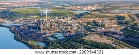 Aerial Panorama Landscape view of Canadian Oil Refinery build along the Athabasca river close to the Oilsands Industrial surface mining area travel Alberta 