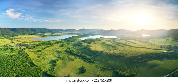 Aerial panorama of meadows, mountain and lakes. Nature landscape scene. - Powered by Shutterstock