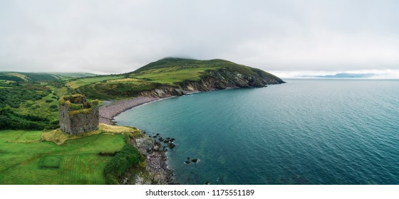 Aerial panorama of the Minard Castle situated on the rocky beach of the Dingle Peninsula with views across the Irish Sea in Kerry county, Ireland. - Powered by Shutterstock