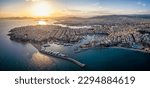 Aerial panorama of the Piraeus district in Athens, Greece, with Zea Marina and the ferry boat harbour in the background during sunset time