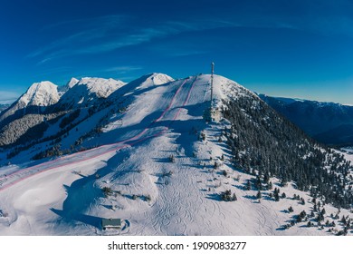 Aerial Panorama Of Ski Slope Of Krvavec In Slovenia, Visible TV Tower Or Antenna And Also A Ski Race Course Between The Red Fence.