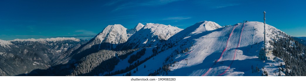 Aerial Panorama Of Ski Slope Of Krvavec In Slovenia, Visible TV Tower Or Antenna And Also A Ski Race Course Between The Red Fence.