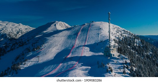 Aerial Panorama Of Ski Slope Of Krvavec In Slovenia, Visible TV Tower Or Antenna And Also A Ski Race Course Between The Red Fence.