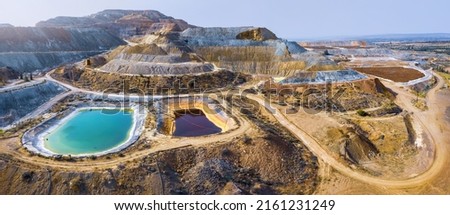Aerial panorama of Skouriotissa copper mine in Cyprus with ore piles and multicolored pools