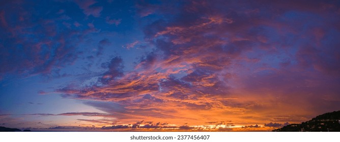 

aerial panorama view amazing cloud with purple shadow in blue sky during beautiful sunset.
Gradient color. abstract nature background.
Scene of colorful orange light trough in the sky background.