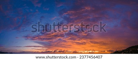 

aerial panorama view amazing cloud with purple shadow in blue sky during beautiful sunset.
Gradient color. abstract nature background.
Scene of colorful orange light trough in the sky background.