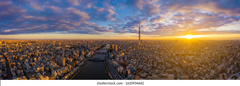 Aerial panorama view by drone of Tokyo Cityscape with Tokyo Sky Tree visible in Tokyo city, Japan on sunrise. Panoramic Dawn view of Tokyo city. Senso-Ji Temple with Sumida river in Japan. - Powered by Shutterstock