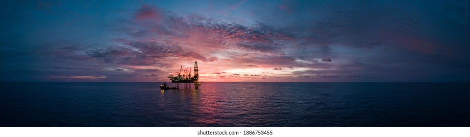 Aerial panorama view from a drone of an offshore jack up rig during sunset time at the offshore location - Shutterstock ID 1886753455