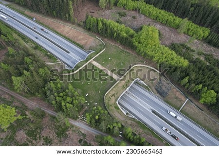 Aerial panorama view of ecoduct or wildlife crossing - vegetation covered bridge over a motorway that allows wildlife to safely cross over,wildlife crossing over busy highway,animal overpass