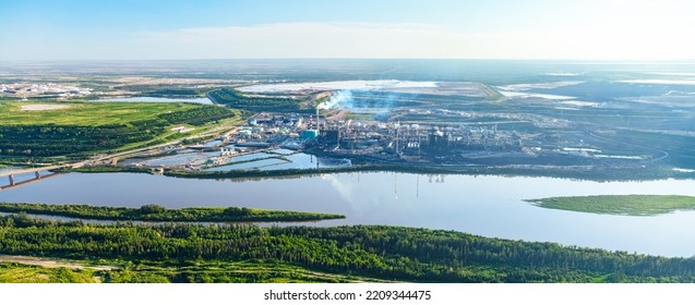 Aerial Panorama view of large Petrochemical oil refinery along the Athabasca River near the Oilsands mining area Fort McMurray travel Alberta Canada