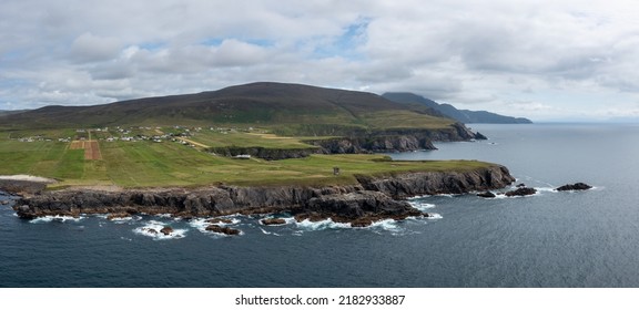 Aerial Panorama View Of The Rugged Coastline Of County Donegal At Malin Beg With The Ruins Of The Napoleonic Signal Tower On The Cliff Edge