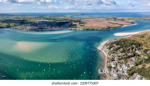 Aerial panorama view of the town and beach of Padstow from Rock on The Camel Estuary in Cornwall, UK which is a popular vacation destination on a sunny Summer day - Powered by Shutterstock