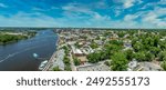 Aerial panorama view of Wilmington North Carolina historic district along the Cape Fear river, with the North Carolina battleship with cloudy sky