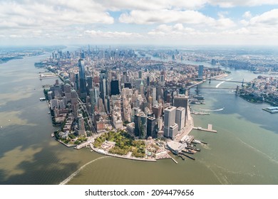 Aerial Panoramic City View On Lower Manhattan District And Financial Downtown, New York City, USA. Bird's Eye View From Helicopter. A Vibrant Business Neighborhood. Hudson River And East River.