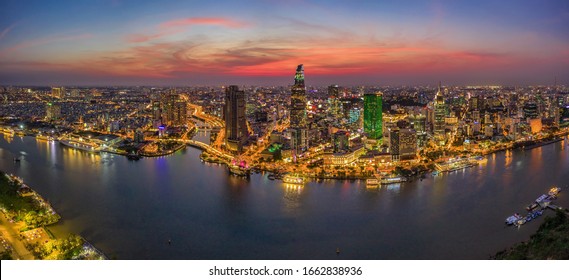 Aerial Panoramic Cityscape View Of HoChiMinh City And The River Saigon, Vietnam With Blue Sky At Sunset. Financial And Business Centers In Developed Vietnam. View From Thu Thiem Peninsula