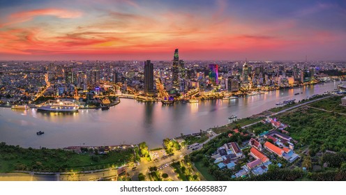 Aerial panoramic cityscape view of HoChiMinh city and the River Saigon, Vietnam with blue sky at sunset. View from ThuThiem peninsula with church and the entrance of the Saigon River tunnel