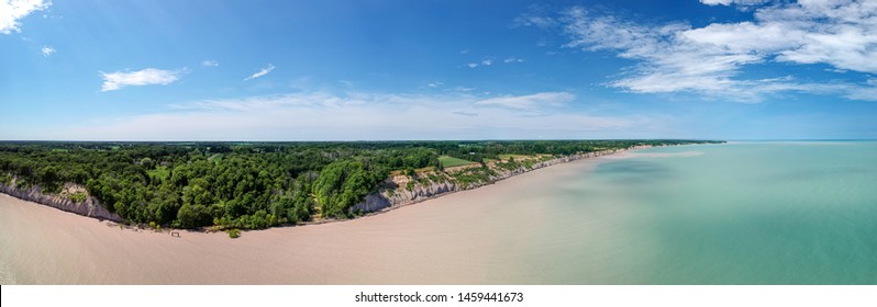 Aerial Panoramic Drone Sea Scape Photo Of Lake Erie Turquoise Water And White Clay Bluffs And High Cliffs With Blue Sky On A Sunny Summer Day. Ontario, Canada.