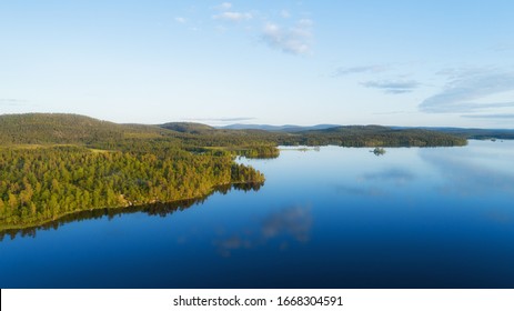 Aerial Panoramic Landscape View Of A Beautiful Bay On The Great Lakes, Lake Inari, During A Vibrant Sunset. Lapland.