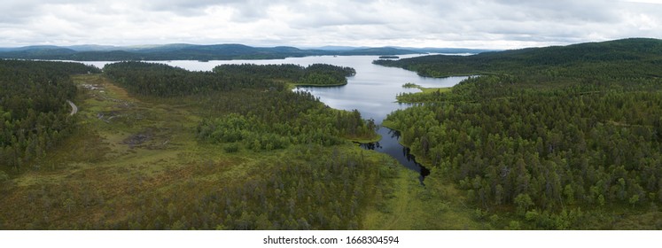 Aerial Panoramic Landscape View Of A Beautiful Bay On The Great Lakes, Lake Inari, During A Vibrant Sunset. Lapland.