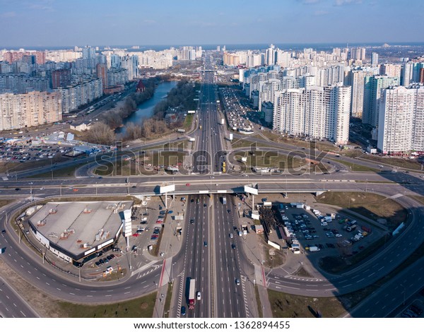 Aerial panoramic\
photography from the drone, bird\'s eye view to Pozniaky district,\
Mykoly Bazhana Ave with traffic and modern building of the city\
Kiev Ukraine at sunset .