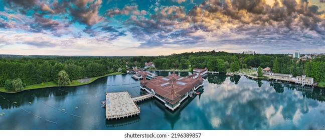 Aerial Panoramic Shot Of Lake Hévíz From Above, Lake Bath With Park And Forest.