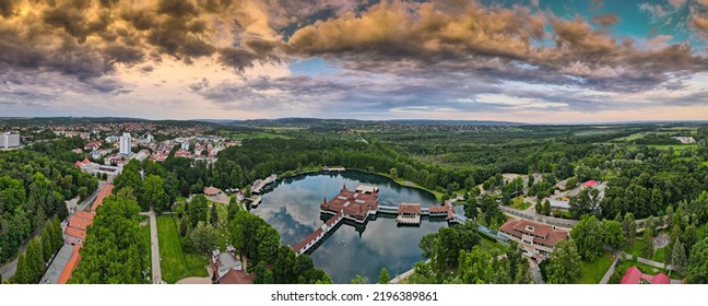 Aerial Panoramic Shot Of Lake Hévíz From Above, Lake Bath With Park And Forest.