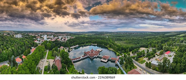 Aerial Panoramic Shot Of Lake Hévíz From Above, Lake Bath With Park And Forest.