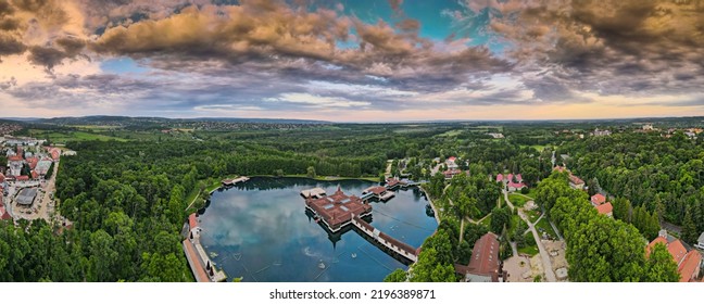 Aerial Panoramic Shot Of Lake Hévíz From Above, Lake Bath With Park And Forest.