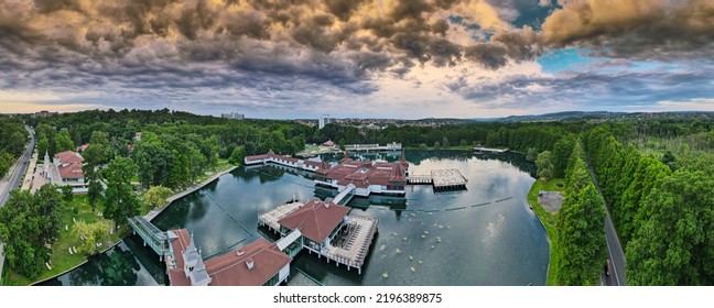 Aerial Panoramic Shot Of Lake Hévíz From Above, Lake Bath With Park And Forest.