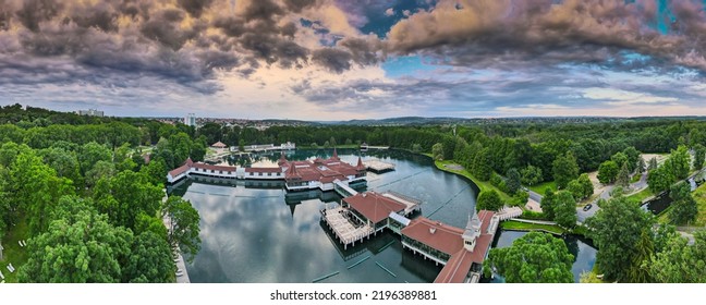 Aerial Panoramic Shot Of Lake Hévíz From Above, Lake Bath With Park And Forest.