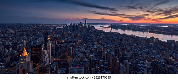 Aerial panoramic skyline of a New York City Sunset over the skyscrapers of Manhattan. Cityscape of Midtown, Lower Manhattan, Financial District and the Hudson River. NYC, USA