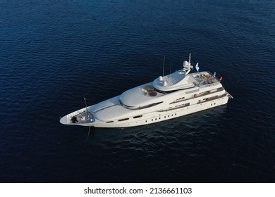 Aerial Panoramic Top Down Drone Photo Of A Super Yacht Anchored In Deep Blue Water In The Mediterranean Sea In Greece