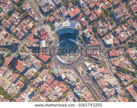 Aerial panoramic top view of the famous insurgents roundabout surrounded by buildings and houses, giant highway junction of mexico city