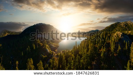 Aerial Panoramic View of Beautiful Glacier Lake in the Canadian Mountain Landscape. Dramatic Colorful Sunset Art Render. Whistler, British Columbia, Canada. Nature Background Panorama
