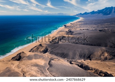 Aerial, panoramic view of the beautiful, unspoiled Cofete beach on the volcanic island of Fuerteventura, Canary Islands, Spain. 