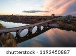 Aerial panoramic view of a bridge going over Saskatchewan River during a vibrant sunrise in the Fall Season. Taken in Saskatoon, SK, Canada.