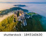 Aerial panoramic view of the Spiš Castle, Slovakia, in the morning sunlight with foggy background and Tatra Mountains seen on the horizon