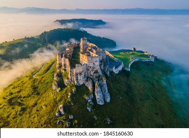 Aerial panoramic view of the Spiš Castle, Slovakia, in the morning sunlight with foggy background and Tatra Mountains seen on the horizon