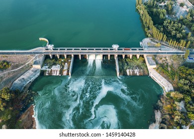 Aerial panoramic view of concrete Dam at reservoir with flowing water, hydroelectricity power station, drone shot. - Shutterstock ID 1459140428